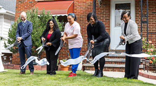 Community leaders cut a ribbon celebrating a child care facility that is now lead safe