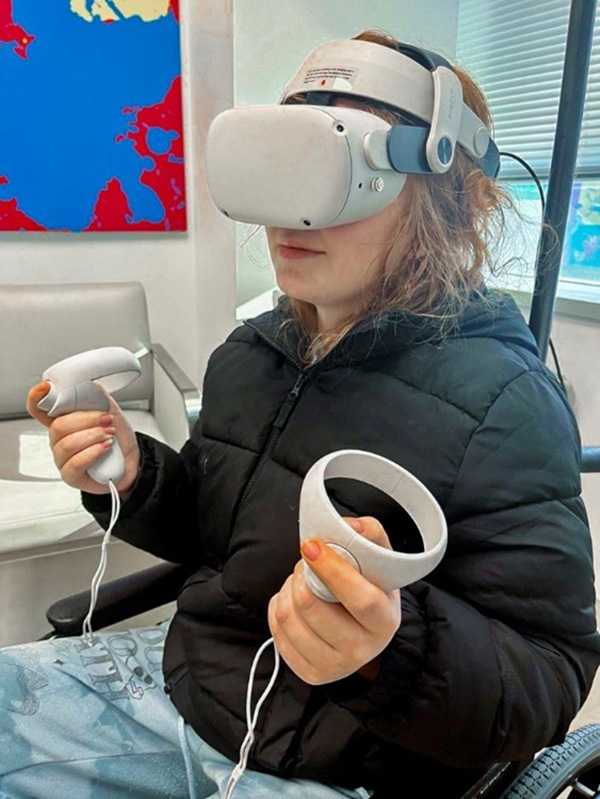 pediatric cancer patient uses a virtual reality headset and controls