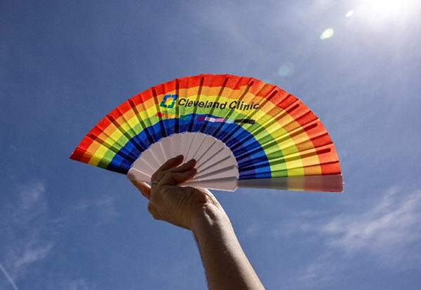 Rainbow pride fan with Cleveland Clinic logo on it